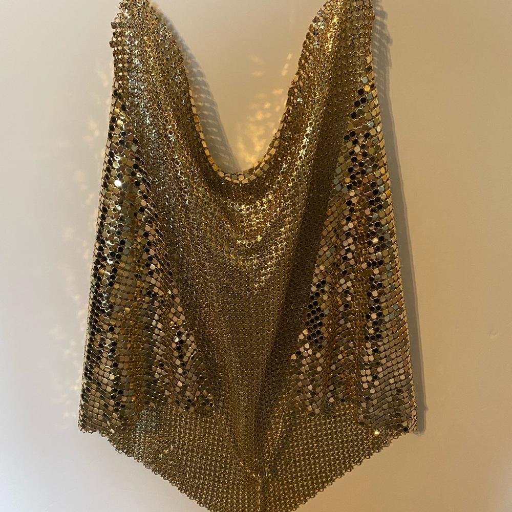 Express gold metal draped top. Chain latch closure around neck and across back.